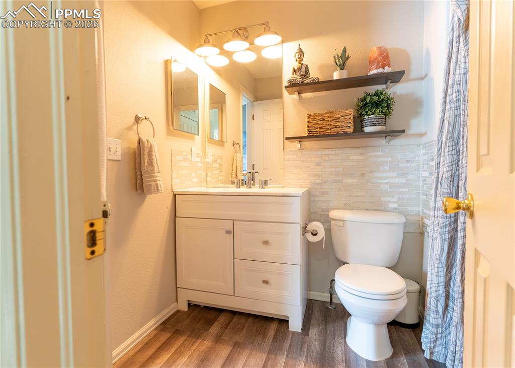 Image 16 of 23: Bathroom featuring vanity, dark wood finished floors, and curtained shower