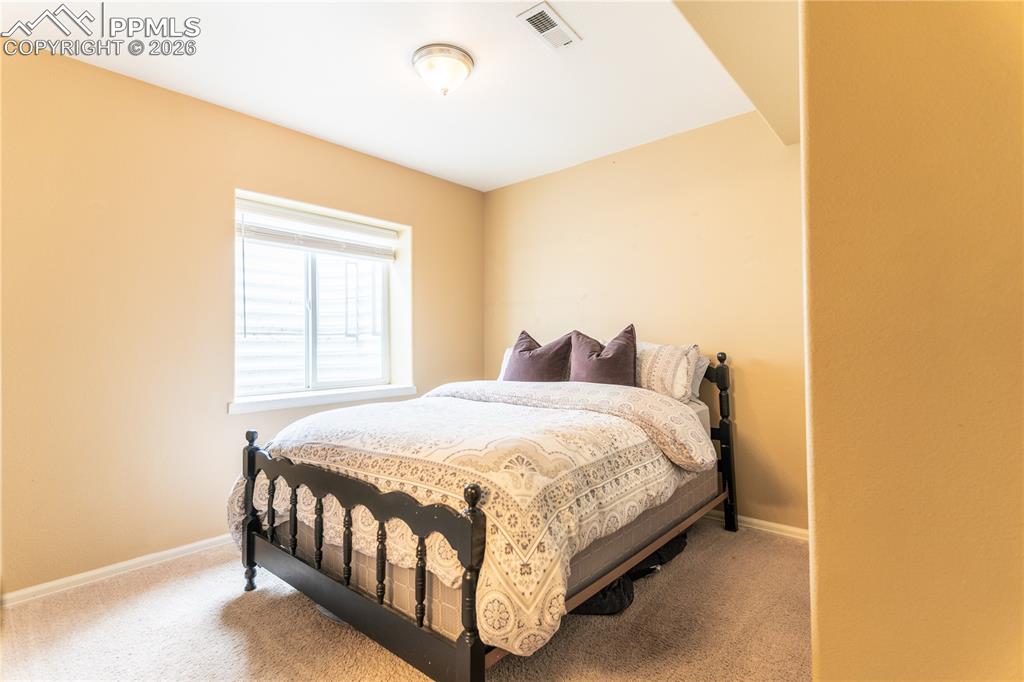 Image 3 of 23: LOWER Bedroom featuring light colored carpet and baseboards