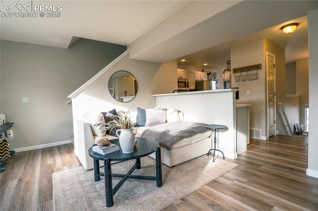 Image 5 of 23: Living area with light wood-style flooring and recessed lighting