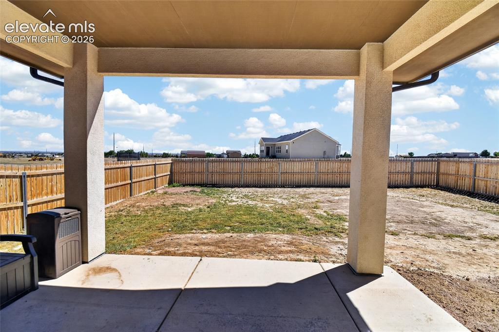Image 15 of 38: Back patio- brand new fence