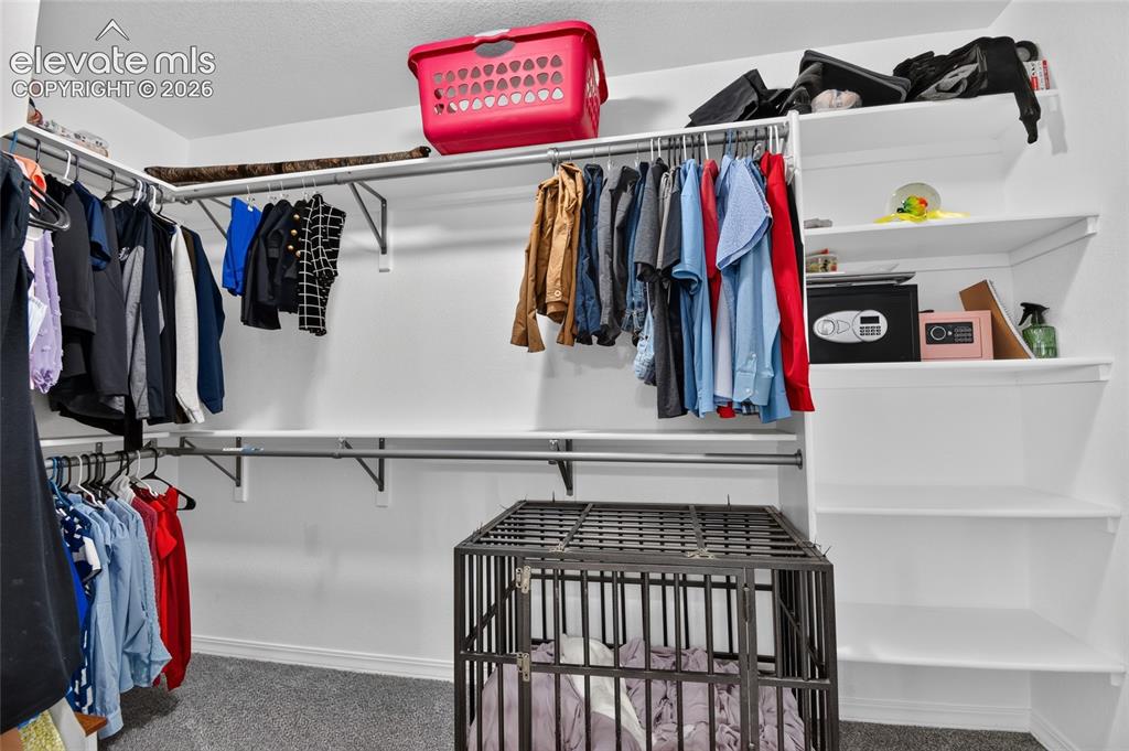 Image 20 of 38: Walk in closet in primary bedroom