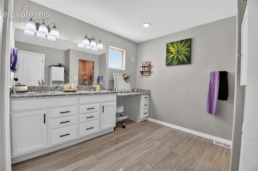 Image 21 of 38: Primary bathroom with sitting area