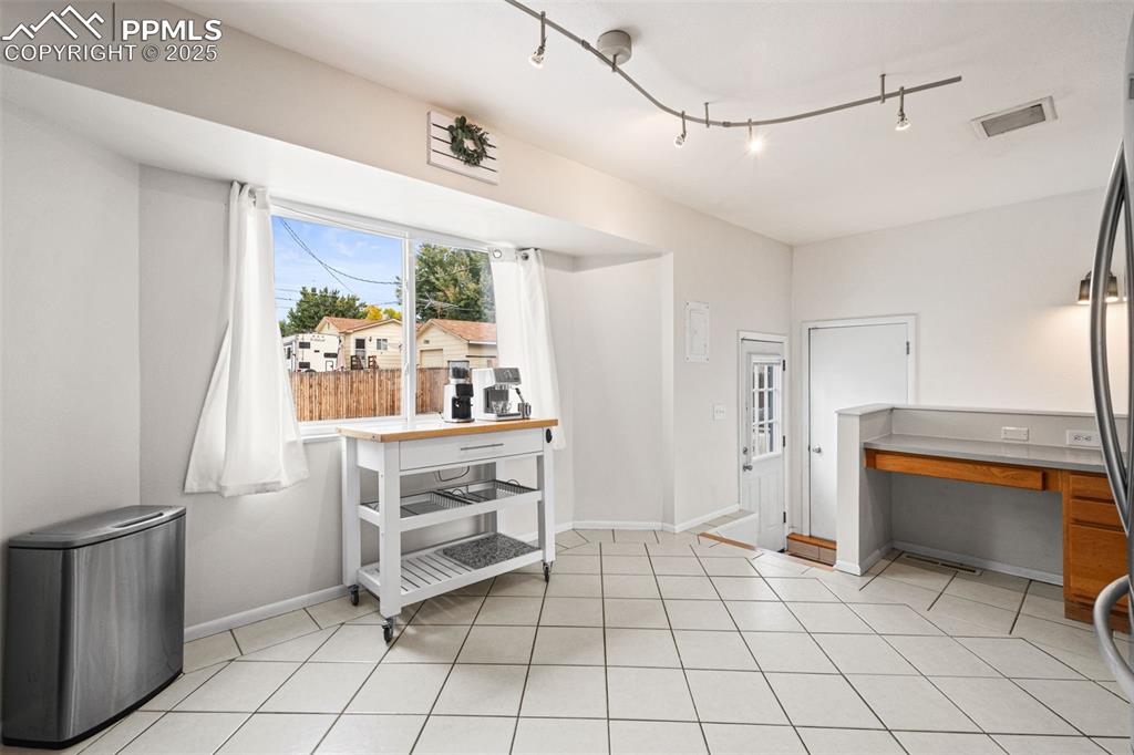 Image 10 of 33: Dining area with light tile patterned floors and baseboards