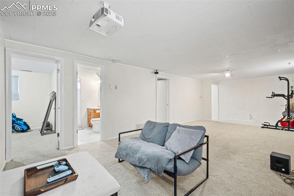 Image 20 of 33: Sitting room with light colored carpet