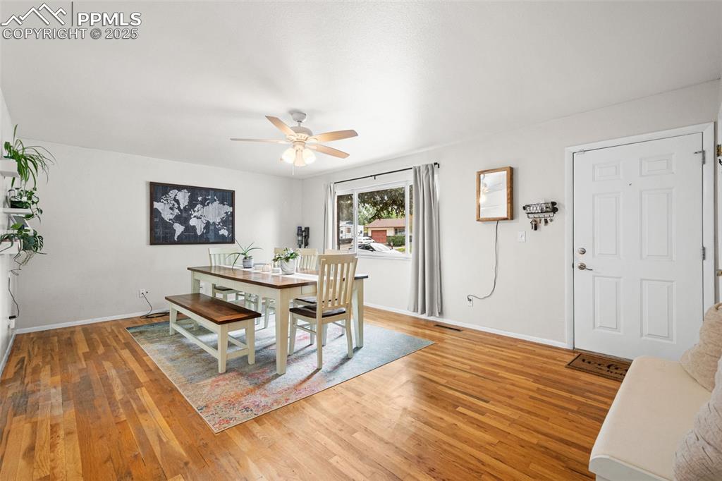 Image 5 of 33: Dining room with light wood-type flooring and a ceiling fan