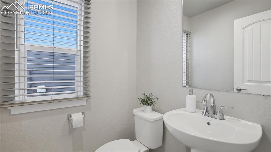 Image 19 of 50: Main level Laundry with window and Samsung washer and dryer.