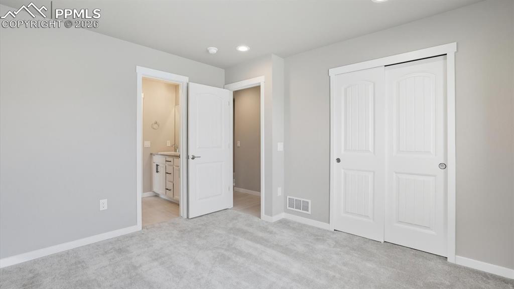 Image 27 of 50: Bedroom #1 off the front Entry with neutral carpet and large view window to