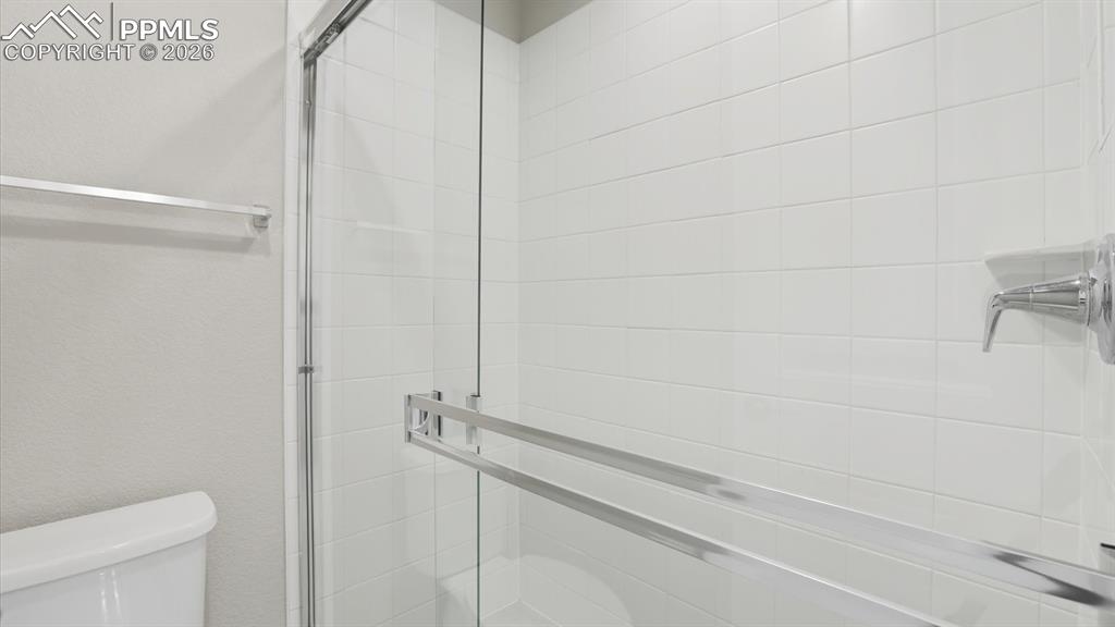 Image 29 of 50: Bedrooms 1 & 2 share a Shower Bathroom with dual sink vanity with quartz co