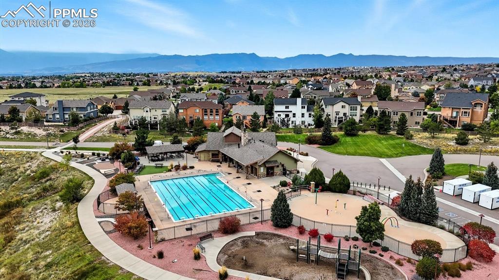 Image 3 of 50: Aerial view of home and corner lot with beautiful mountain views.