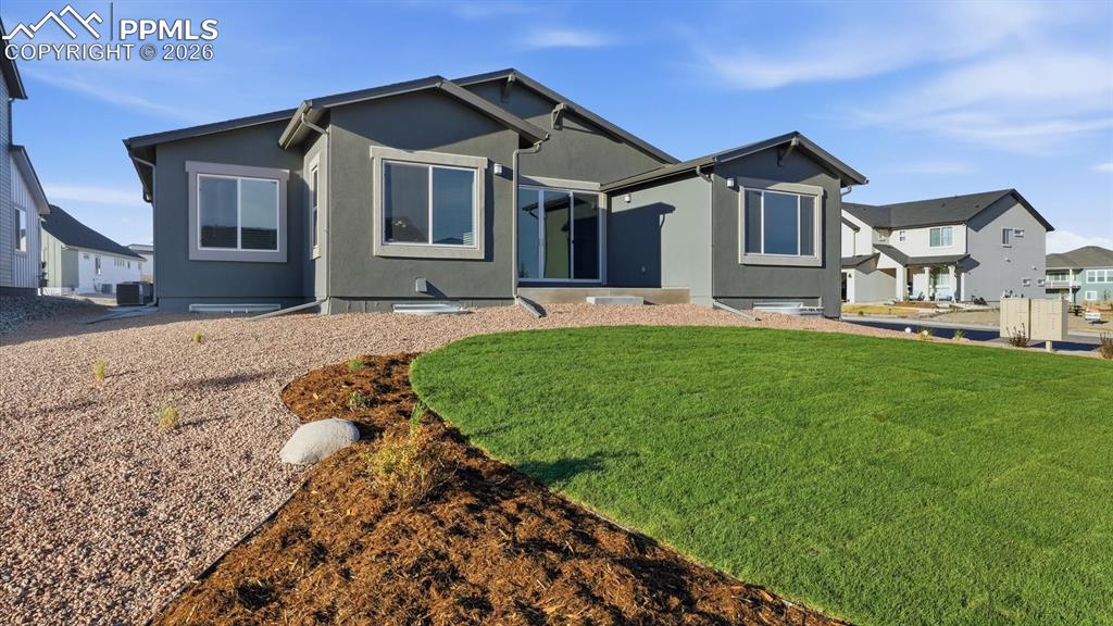 Image 45 of 50: Rear view of home and 0.27 acre corner lot.