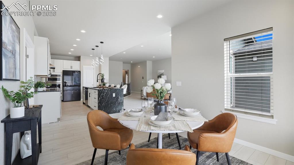 Image 9 of 50: Sunny Dining Area located off the Kitchen for convenient food service, ente