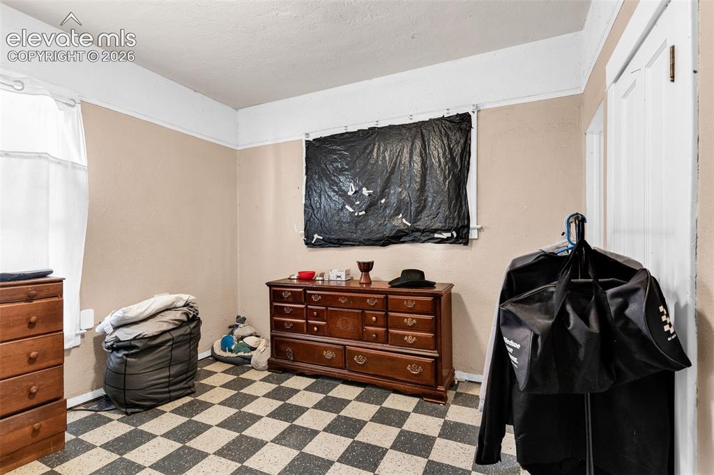 Image 17 of 31: Checkered floor tiling, neutral wall tones, and white trim