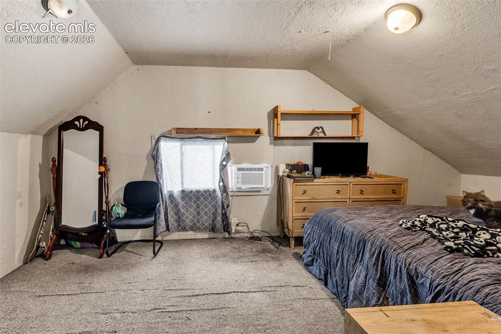 Image 22 of 31: Sloped ceilings with recessed lighting, light-colored wall paint, and wall-
