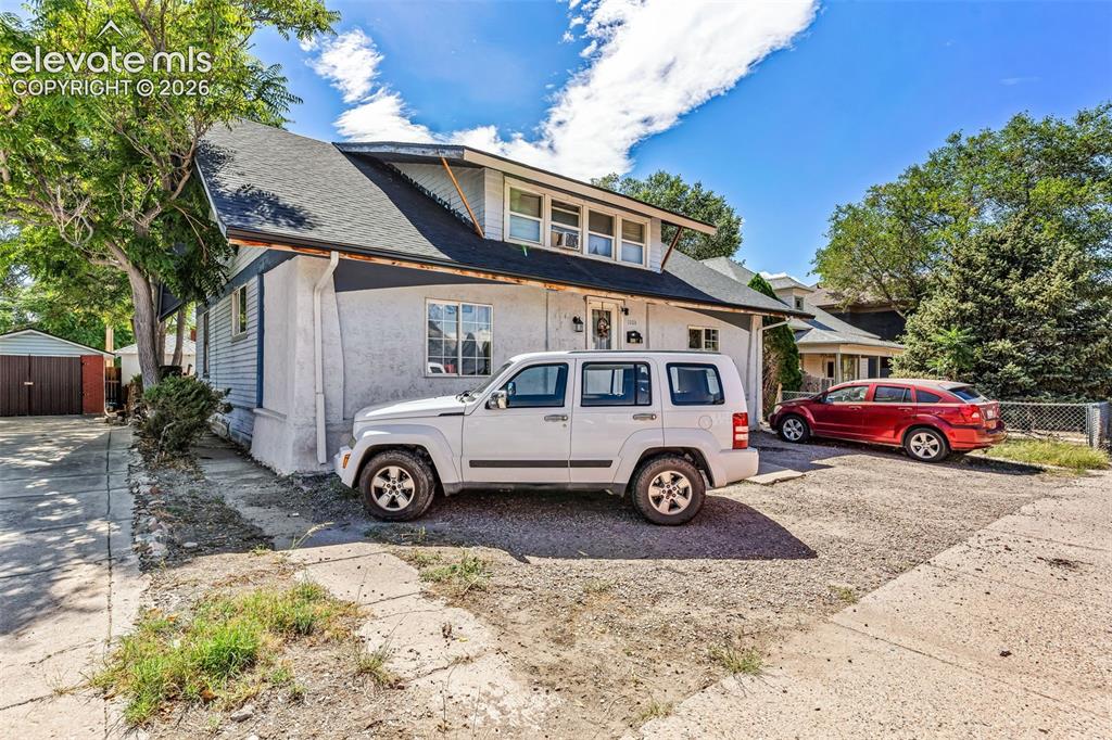 Image 3 of 31: Exterior featuring a multi-story design, dormer windows, and a dark shingle