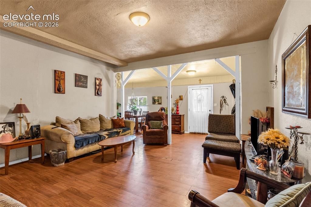 Image 6 of 31: Wood-finish flooring throughout, with a framed entryway creating a defined 