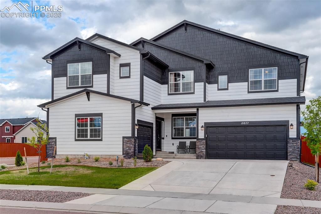 Image 1 of 50: Craftsman house featuring two attached garages, concrete driveway, wood and