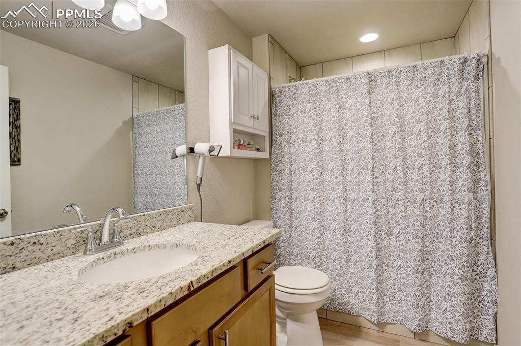 Image 18 of 50: Lower Level; basement Full bathroom featuring stone vanity, shower/tub with