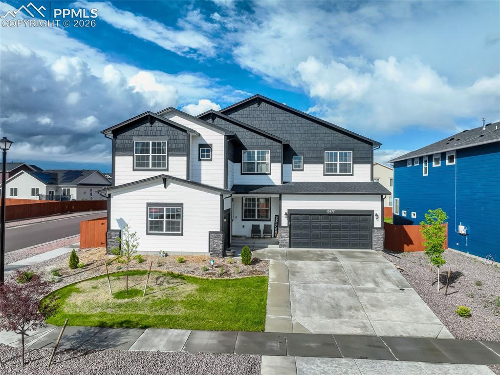 Image 2 of 50: Craftsman house featuring two attached garages, concrete driveway, wood and