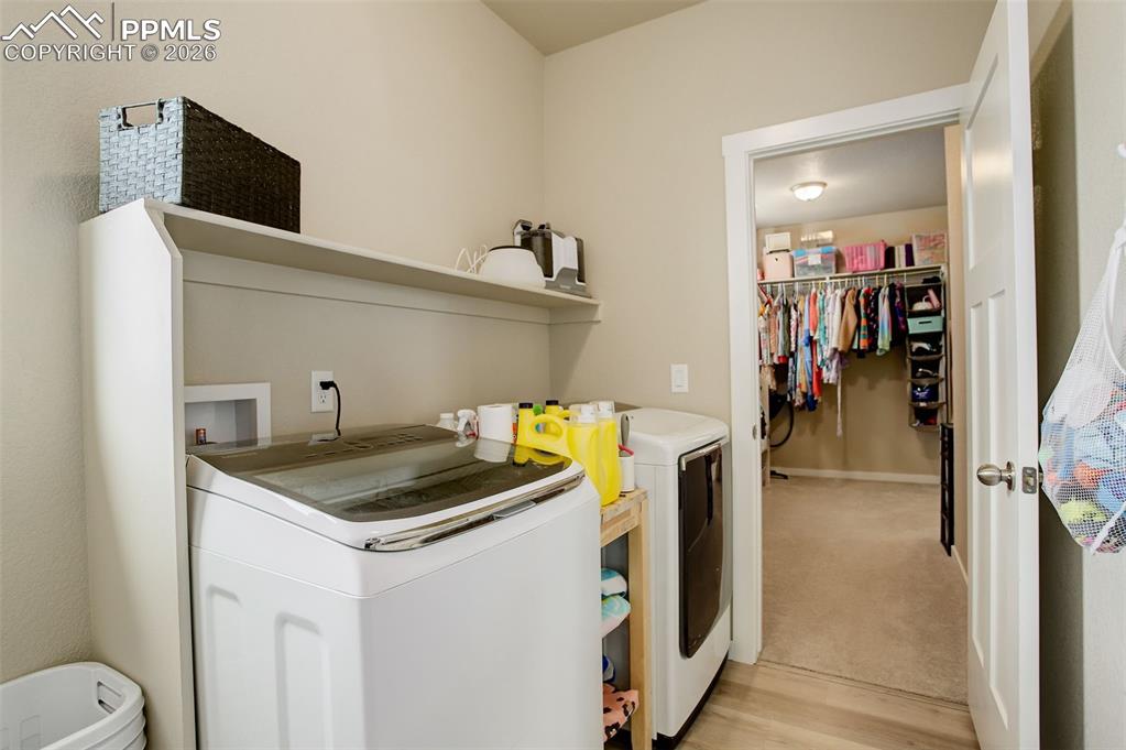 Image 20 of 50: Upper level laundry - adjoins the primary bedrooms walk-in closet that is a