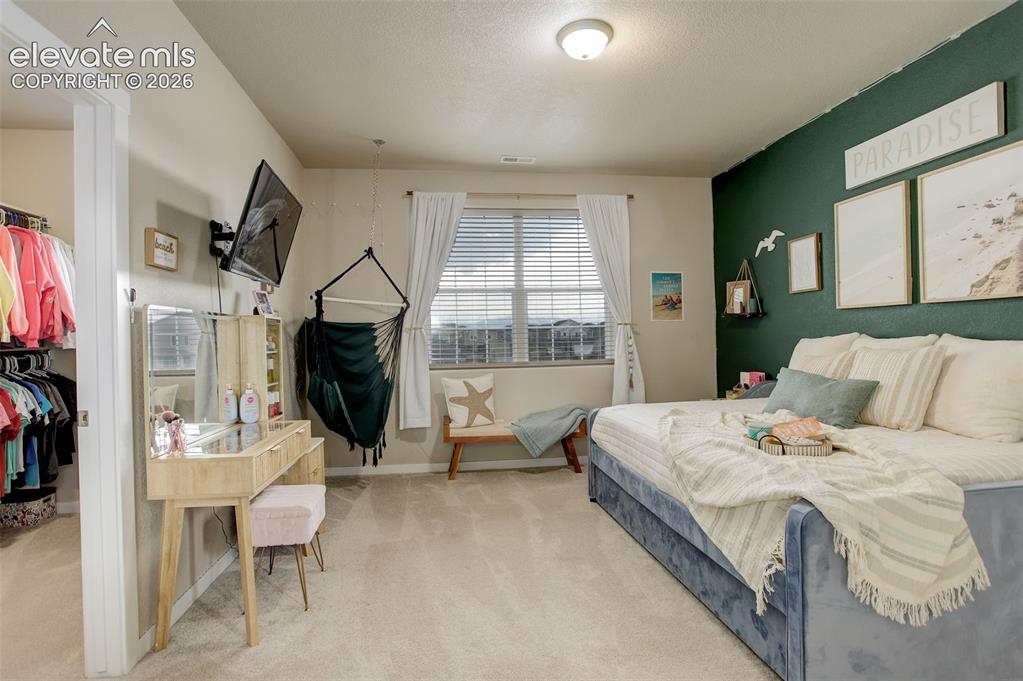 Image 20 of 50: Upstairs/West facing large Bedroom featuring a walk-in close and adjoining