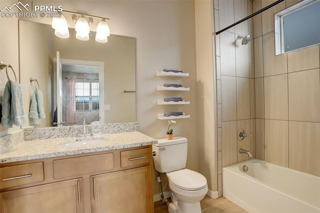 Image 26 of 50: Carpeted bedroom featuring baseboards and connected bathroom