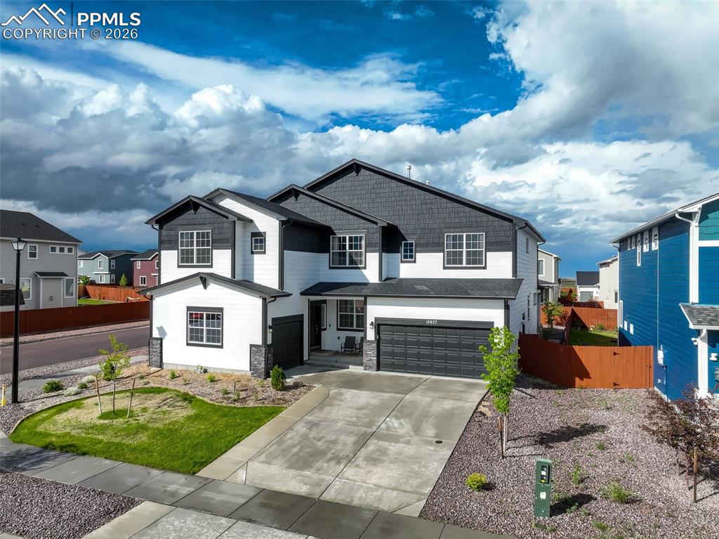 Image 3 of 50: Craftsman house featuring two attached garages, concrete driveway, wood and