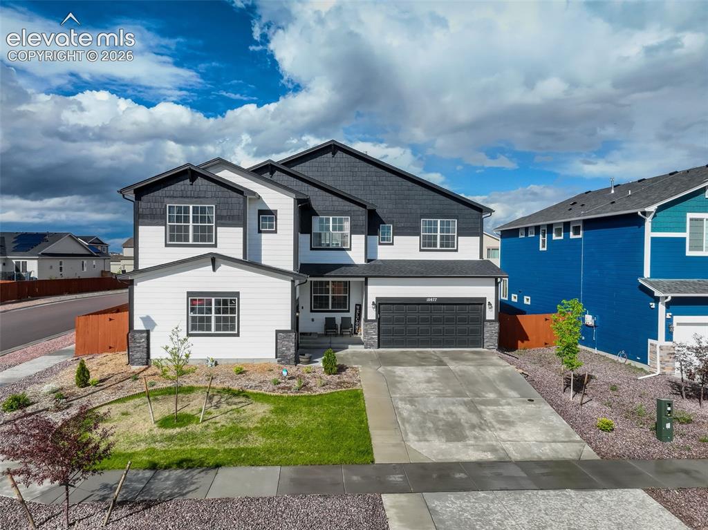 Image 3 of 50: Craftsman house featuring two attached garages, concrete driveway, wood and