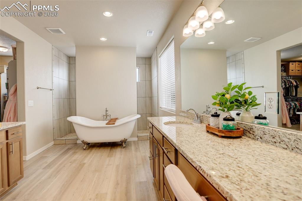 Image 30 of 50: Dining room featuring light wood finished floors, a tray ceiling, and a cha