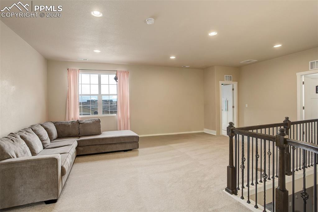 Image 32 of 50: Living room with recessed lighting and carpet, spacious and bright 
