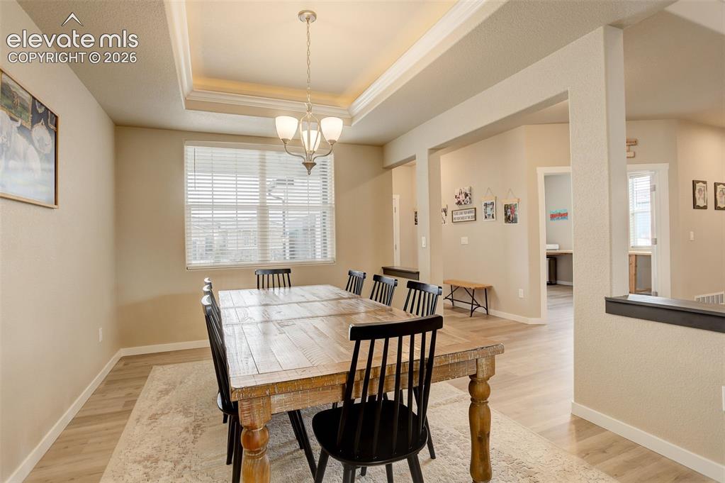 Image 33 of 50: Living area, white oak LVP, recessed lighting, and oversized windows.