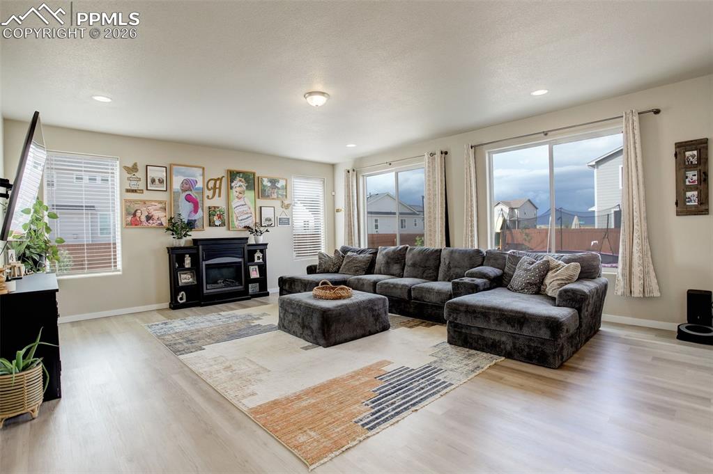 Image 35 of 50: Main level; Living area featuring wood finished floors, a glass covered fir