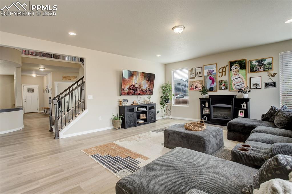 Image 36 of 50: Main level; Living area with light wood finished floors and recessed lighti