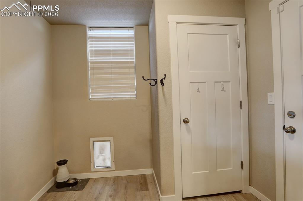 Image 38 of 50: Main-Level; mud room with coat closet, dog door to dog run and door to gara