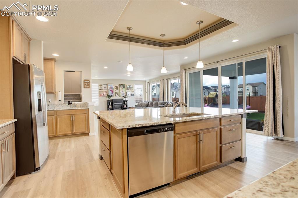 Image 39 of 50: Kitchen with stainless steel appliances, a raised ceiling, a kitchen breakf