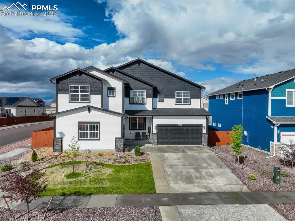 Image 4 of 50: Craftsman house featuring two attached garages, concrete driveway, wood and