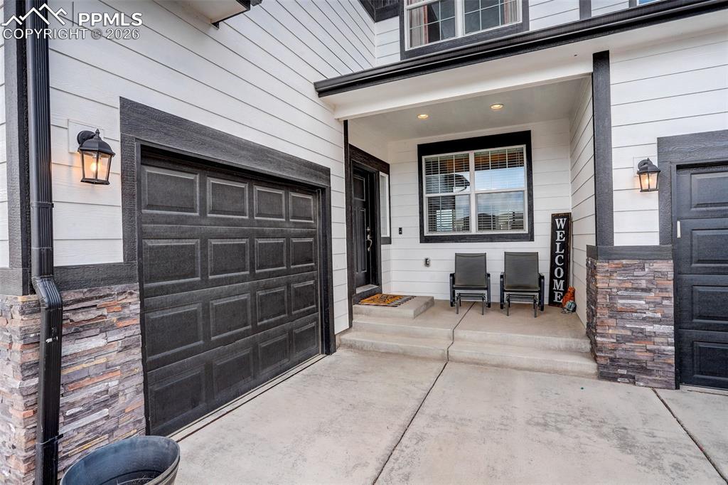Image 7 of 50: View of exterior entry - near single car garage (1 of 3 parking garages. Th