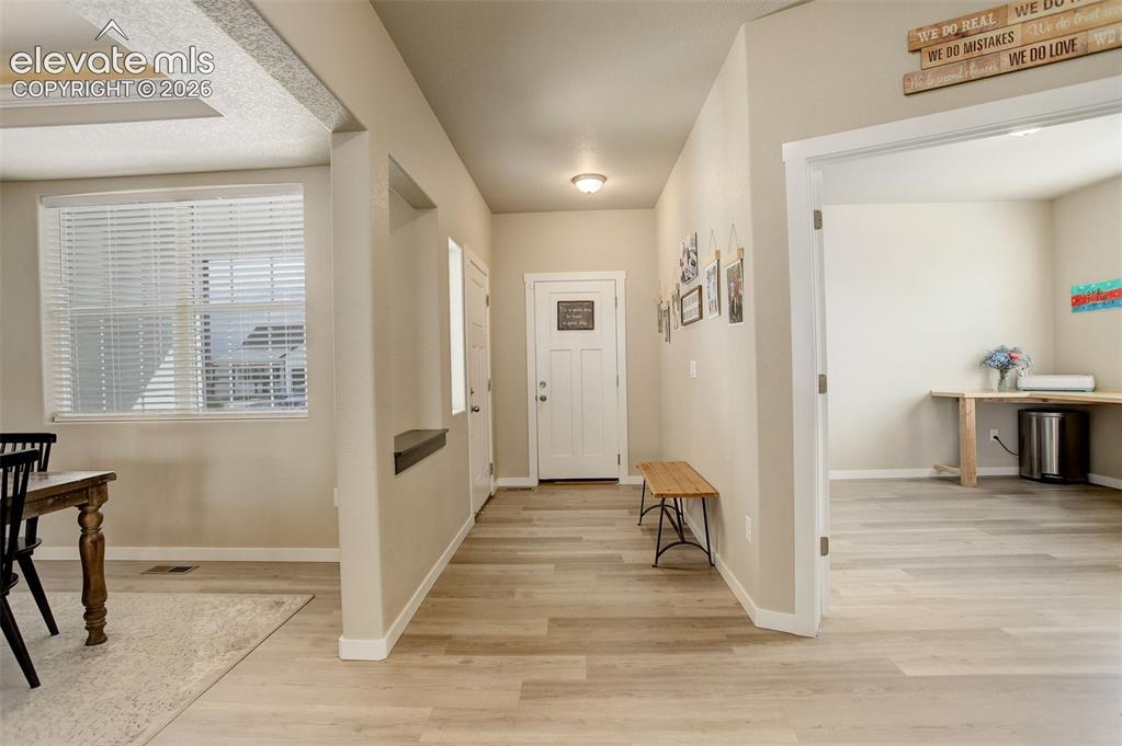 Image 7 of 50: Foyer entrance featuring white oak LVP flooring.
