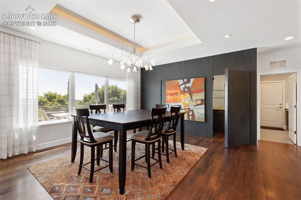 Image 14 of 50: Dining Room with Hidden Bar & Pantry