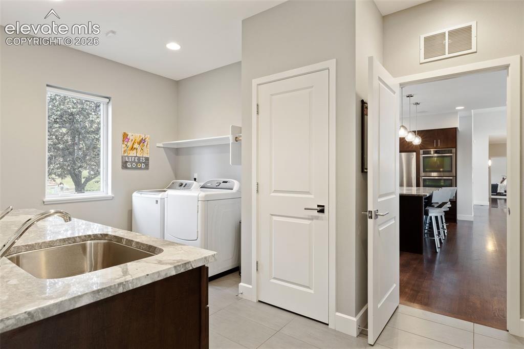 Image 18 of 50: Large Laundry connects the Garage & Kitchen