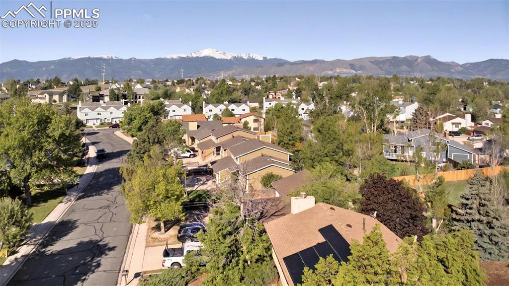 Image 23 of 25: View of property location with a mountainous background and nearby suburban