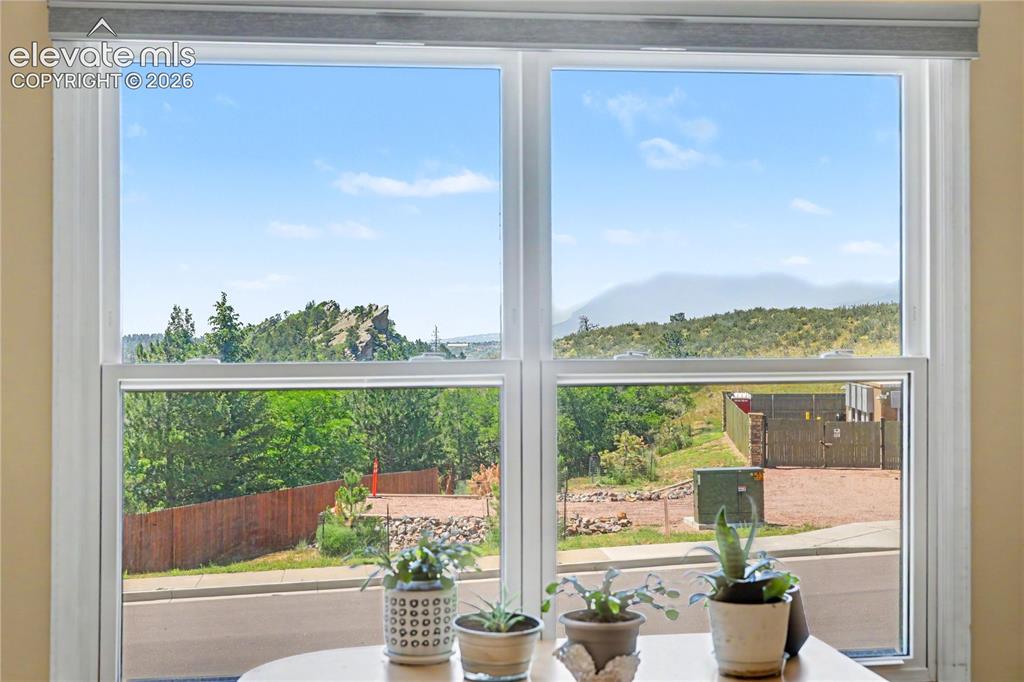 Image 16 of 25: View of mountains from upper level guest bedroom