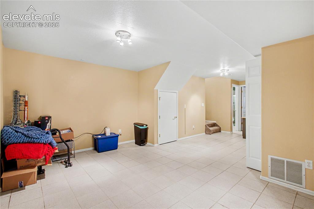 Image 21 of 25: Large area in lower level that can be used as an office or second family or