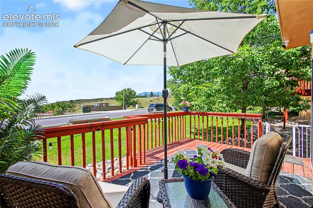 Image 22 of 25: Lovely roomy expanded deck with views of mountains