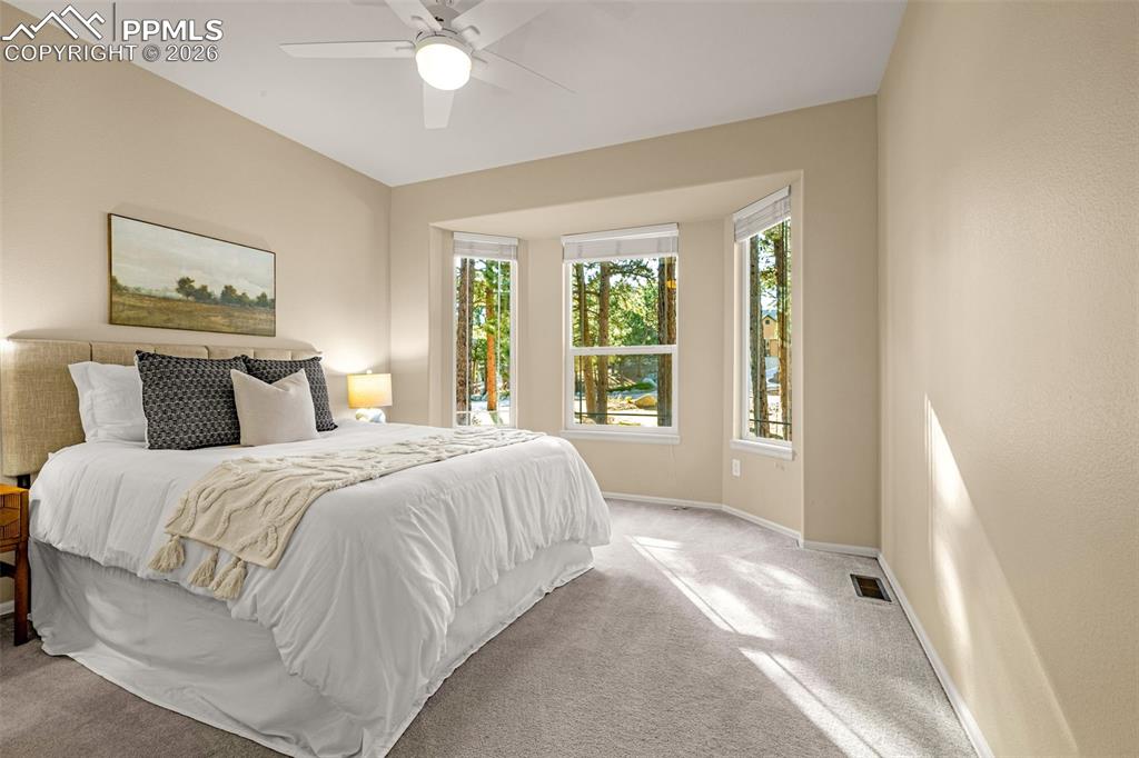 Image 18 of 40: This room features a bay window providing abundant natural light and views 