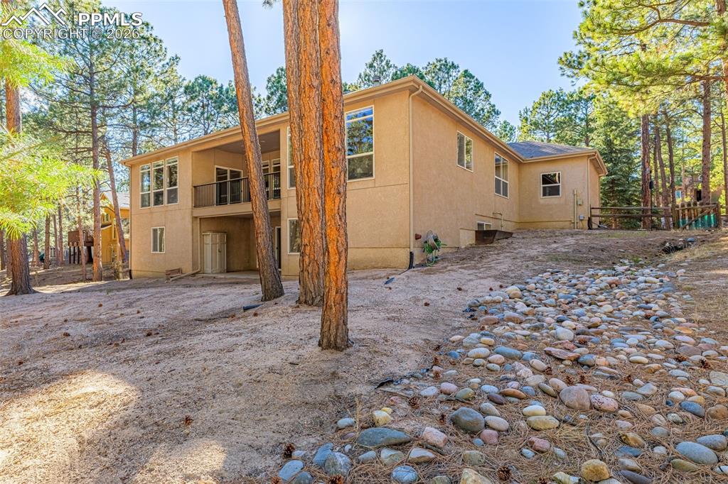 Image 35 of 40: This property features an expansive exterior with a stucco finish, surround