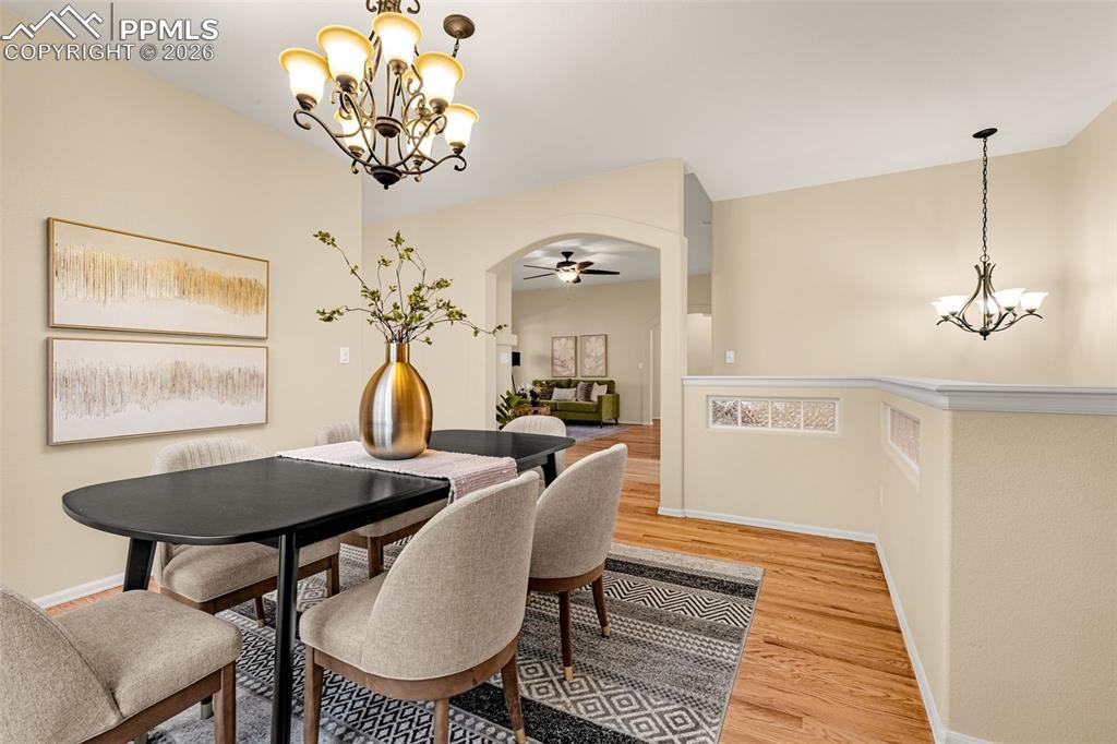 Image 9 of 40: This dining area features hardwood floors and a decorative chandelier, with