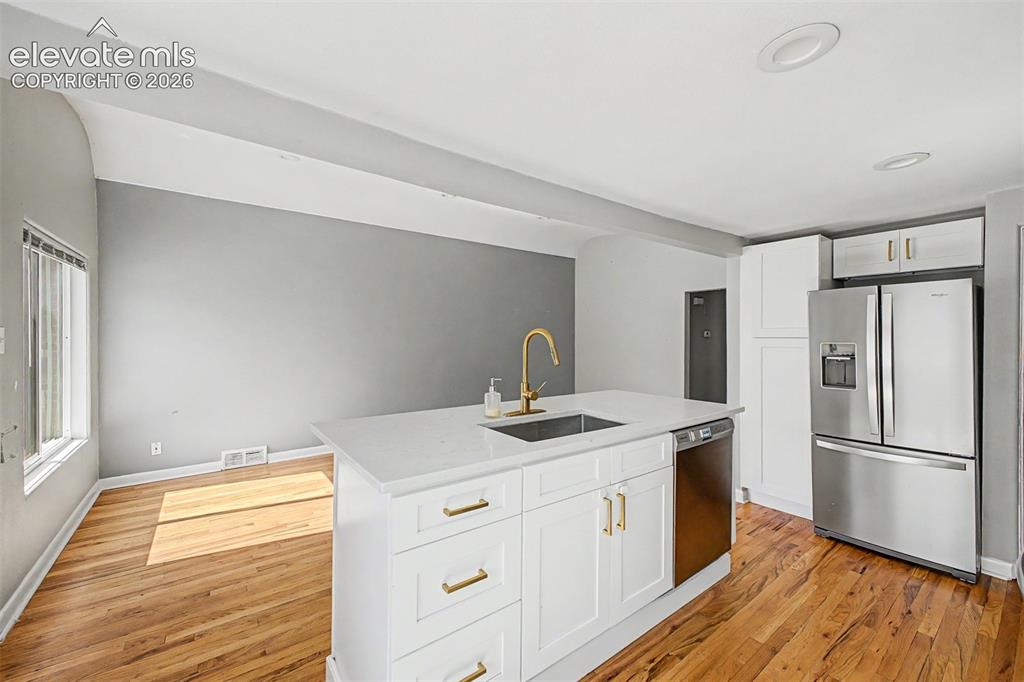 Image 16 of 40: Primary bedroom featuring hardwood flooring, light gray walls and h