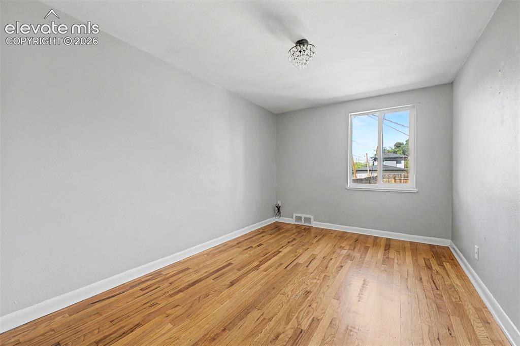 Image 21 of 40: Hardwood flooring throughout, complemented by light gray walls