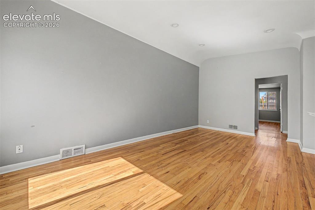 Image 3 of 40: Open-concept kitchen and living area featuring wood-finish flooring, recess