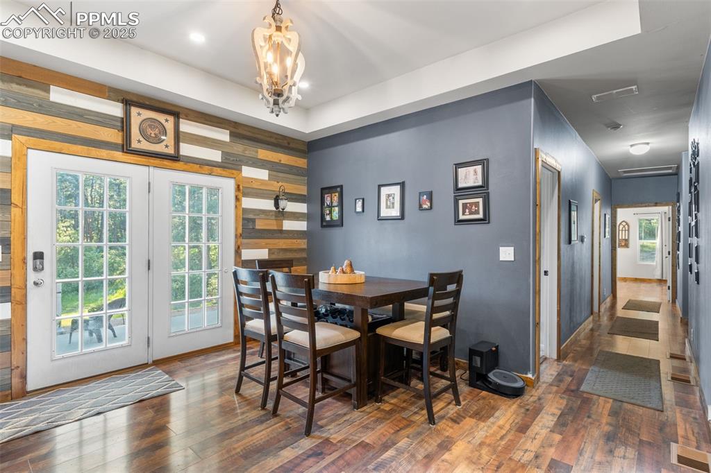 Image 11 of 46: Dining space featuring hardwood / wood-style floors, a chandelier, and wood